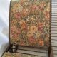 Wooden footrest and vintage tapestry