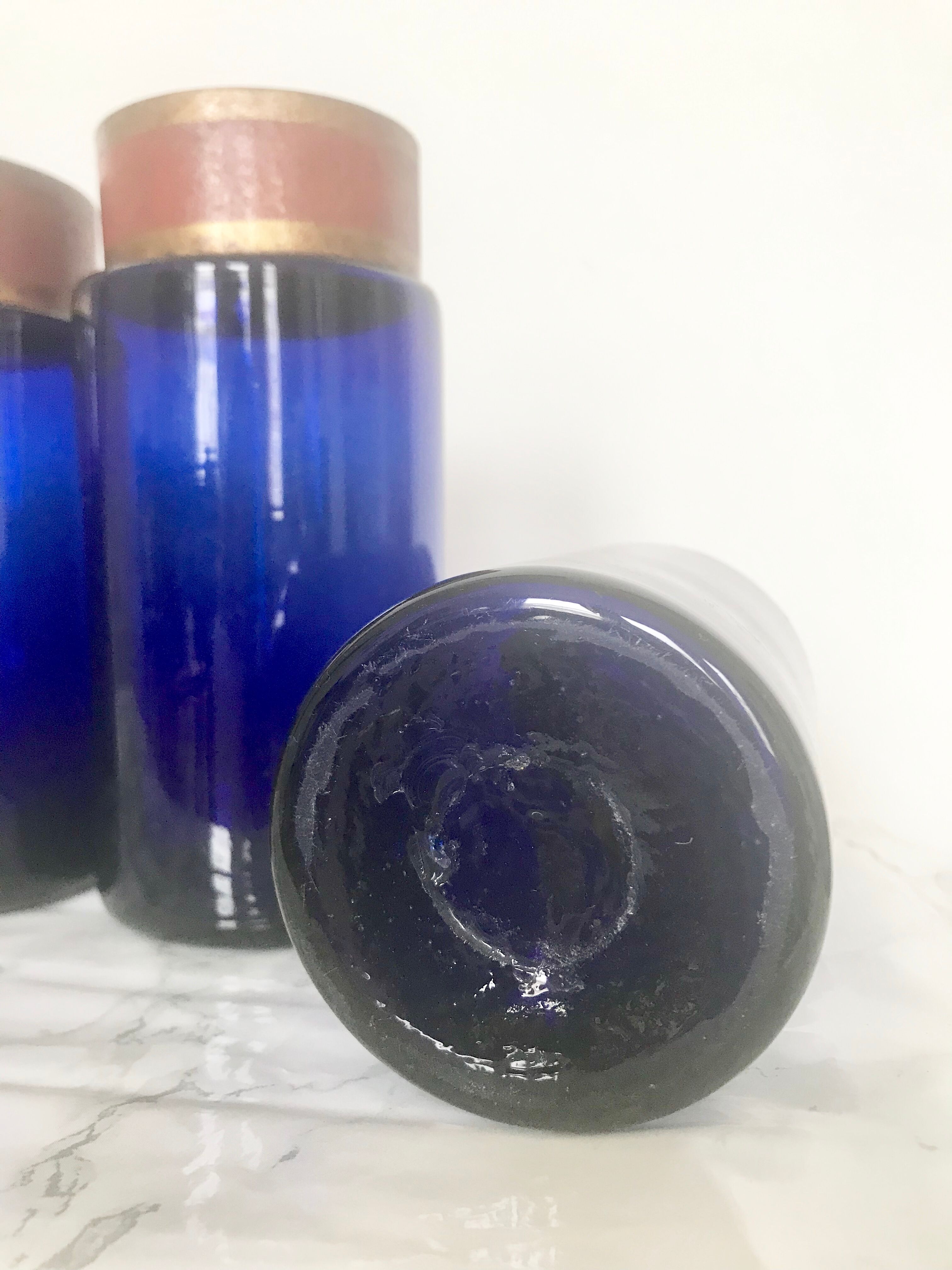 Suite of four bottles of ancient apothecary in blue breath glass