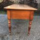 Antique cherry farmhouse table with turned legs and 2 drawers.