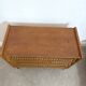 Vintage commode with tapered legs in rattan.