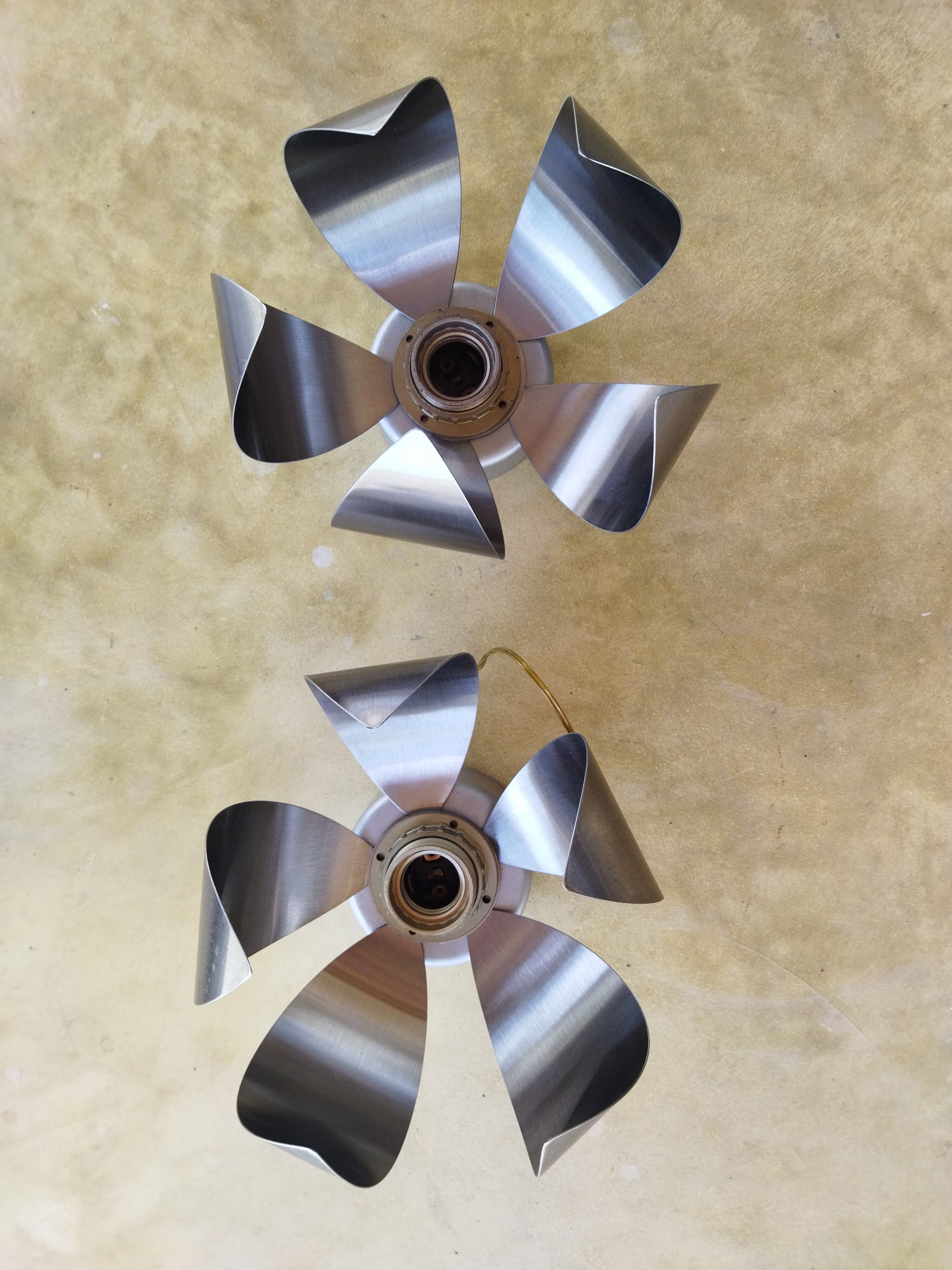 A set of brushed stainless steel flowers sconces