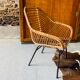 Rattan armchair and black metal base 1960