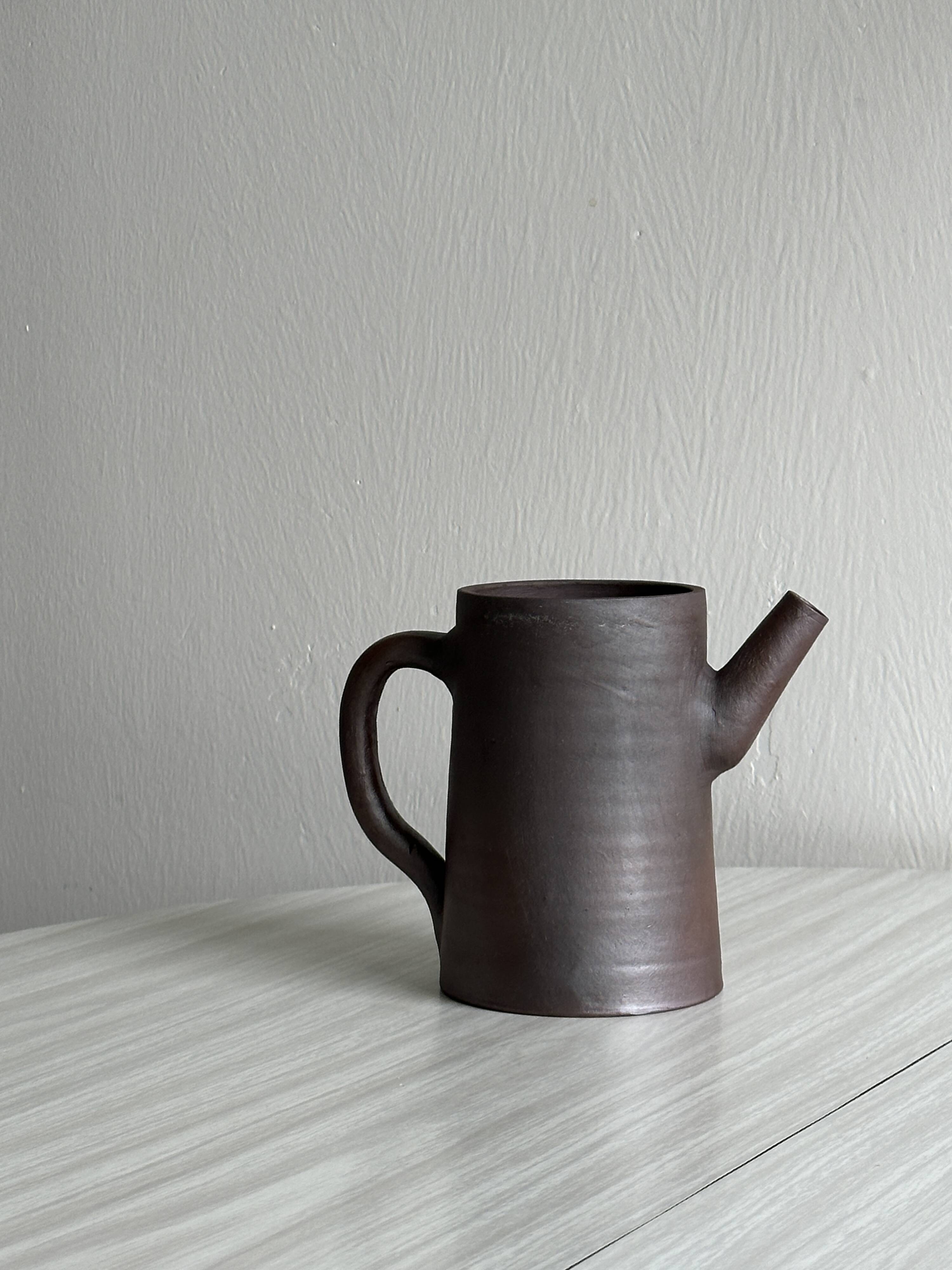 Small pitcher in brown glazed stoneware