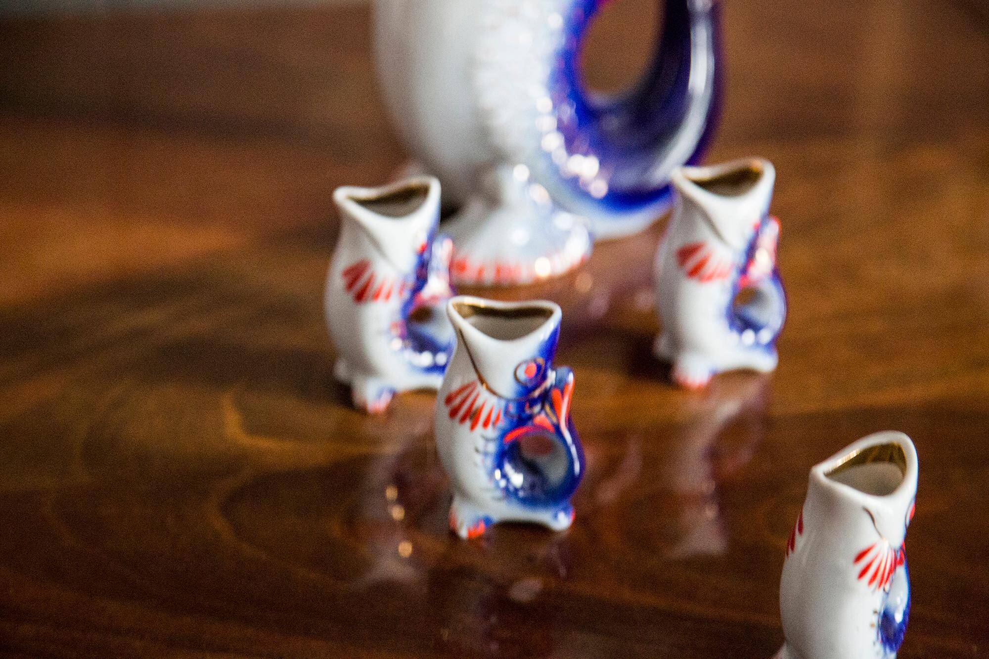 Set of 7 glasses and a glass carafe decorated with blue fish, Mid-Century Modern style, Europe, 1960s.