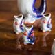 Set of 7 glasses and a glass carafe decorated with blue fish, Mid-Century Modern style, Europe, 1960s.