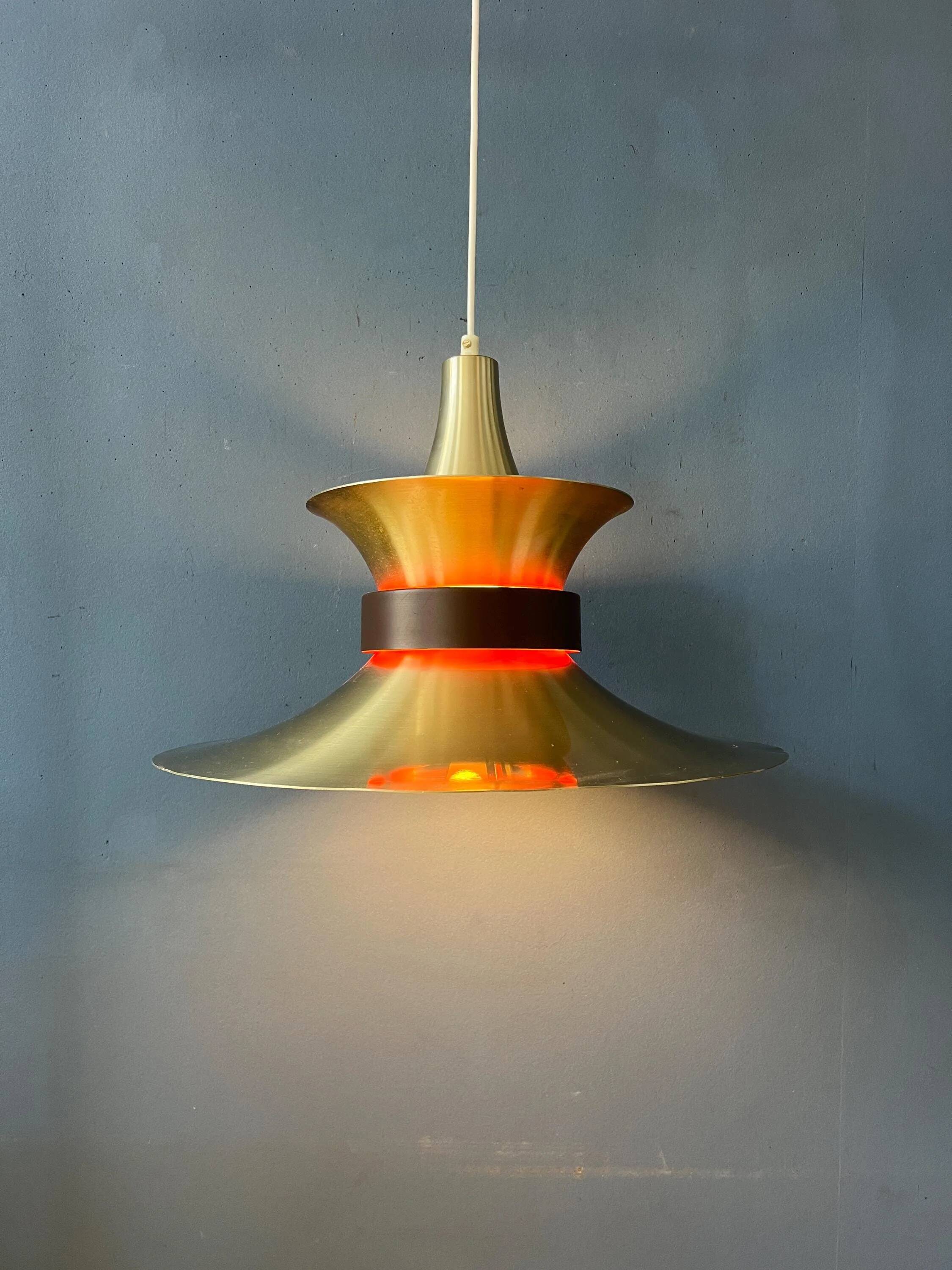 Large UFO flying saucer pendant light with orange light.