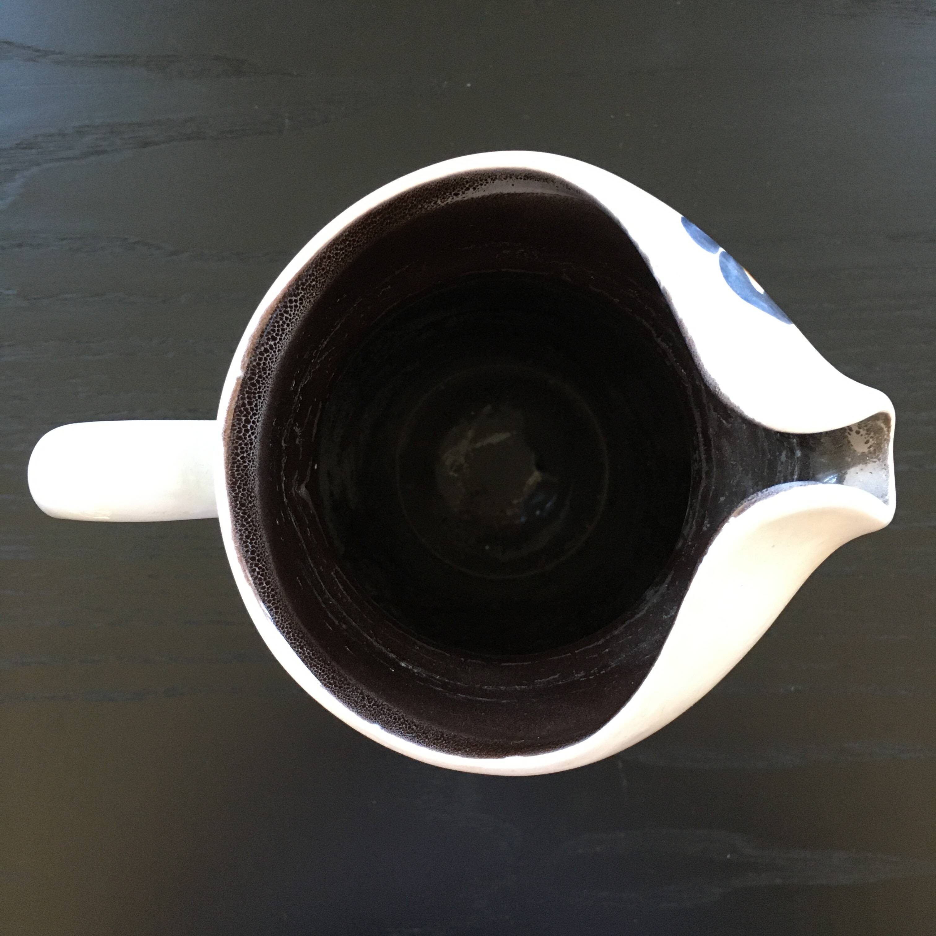 White pitcher with floral decoration