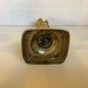 Brass candlestick with a rectangular base.
