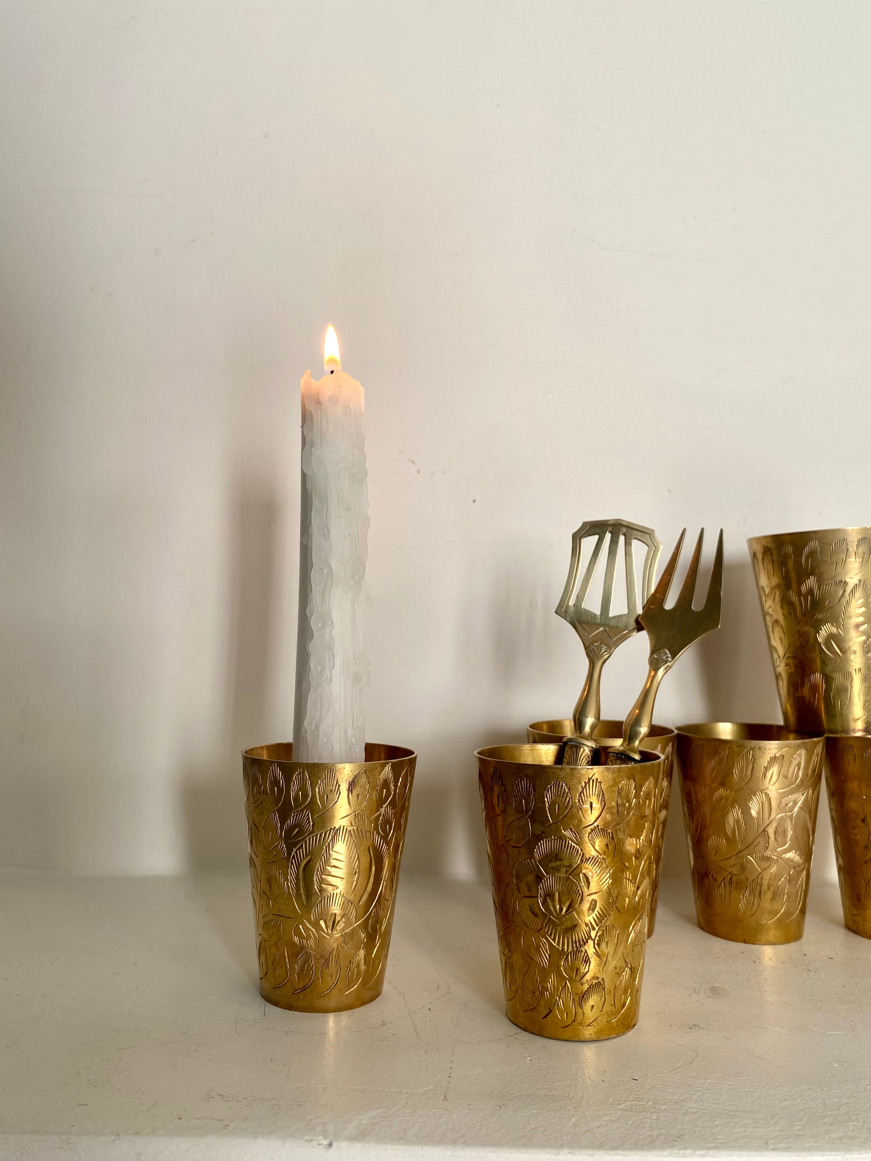 Six chiseled metal glasses