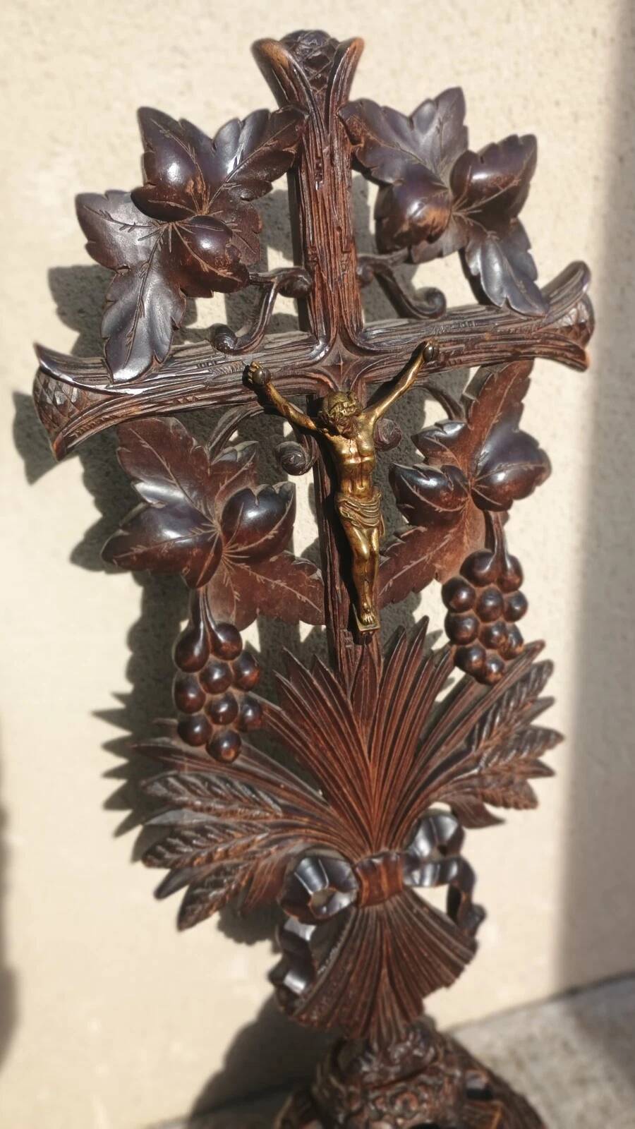 Antique wooden crucifix carved from the Black Forest with grapes and leaves.