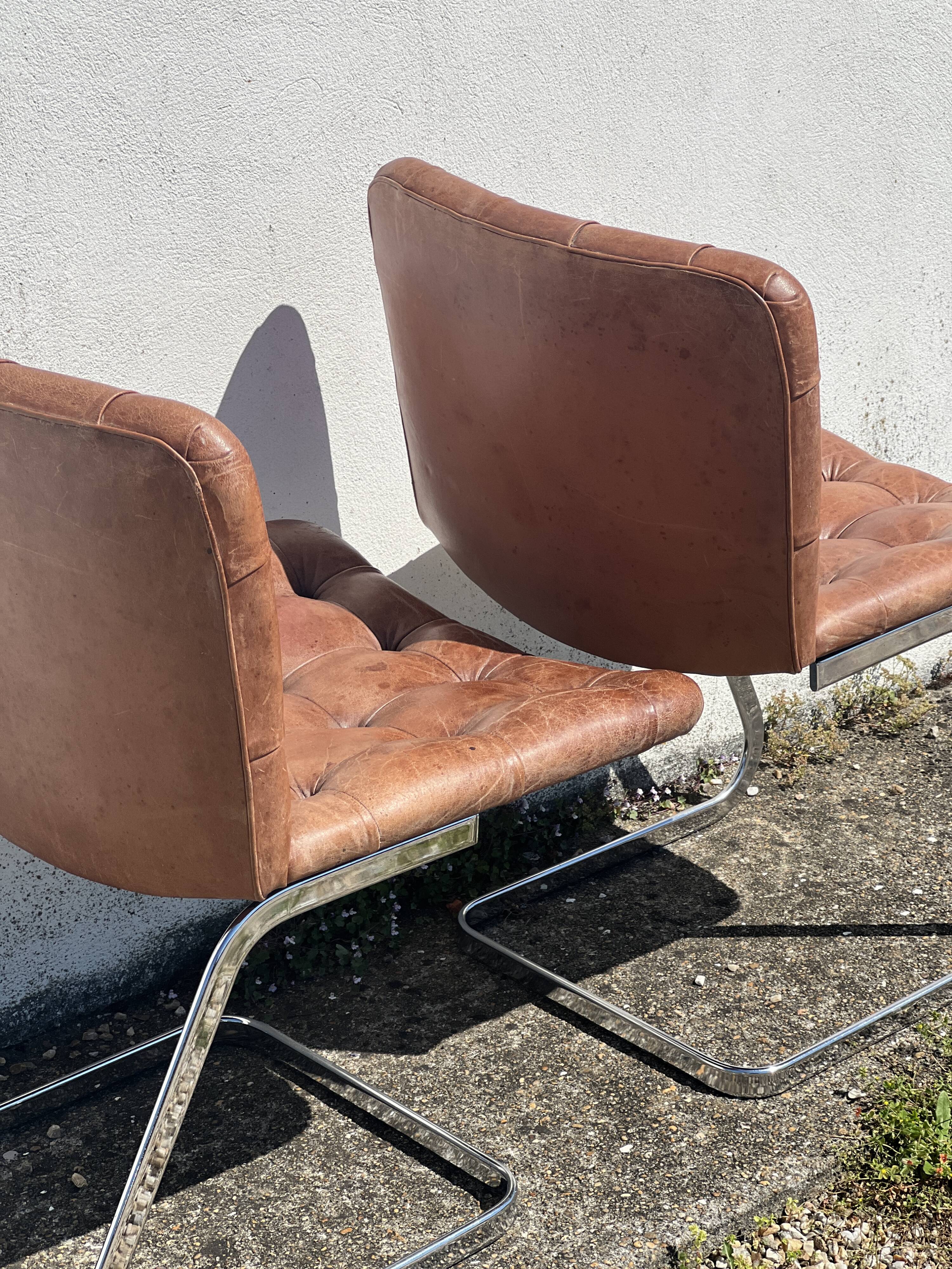 Pair of leather chairs by Robert Haussman