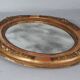 Antique oval mirror with original stucco and gilt wood frame, 37x31 cm. Beautiful patina.