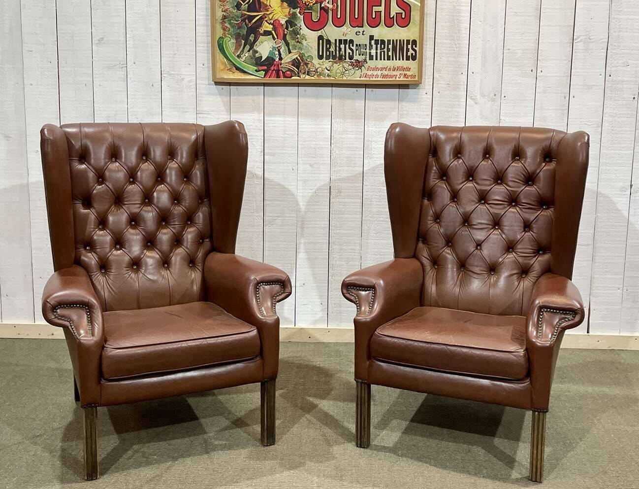 Pair of brown leather wingback Chesterfield armchairs from the 1970s.
