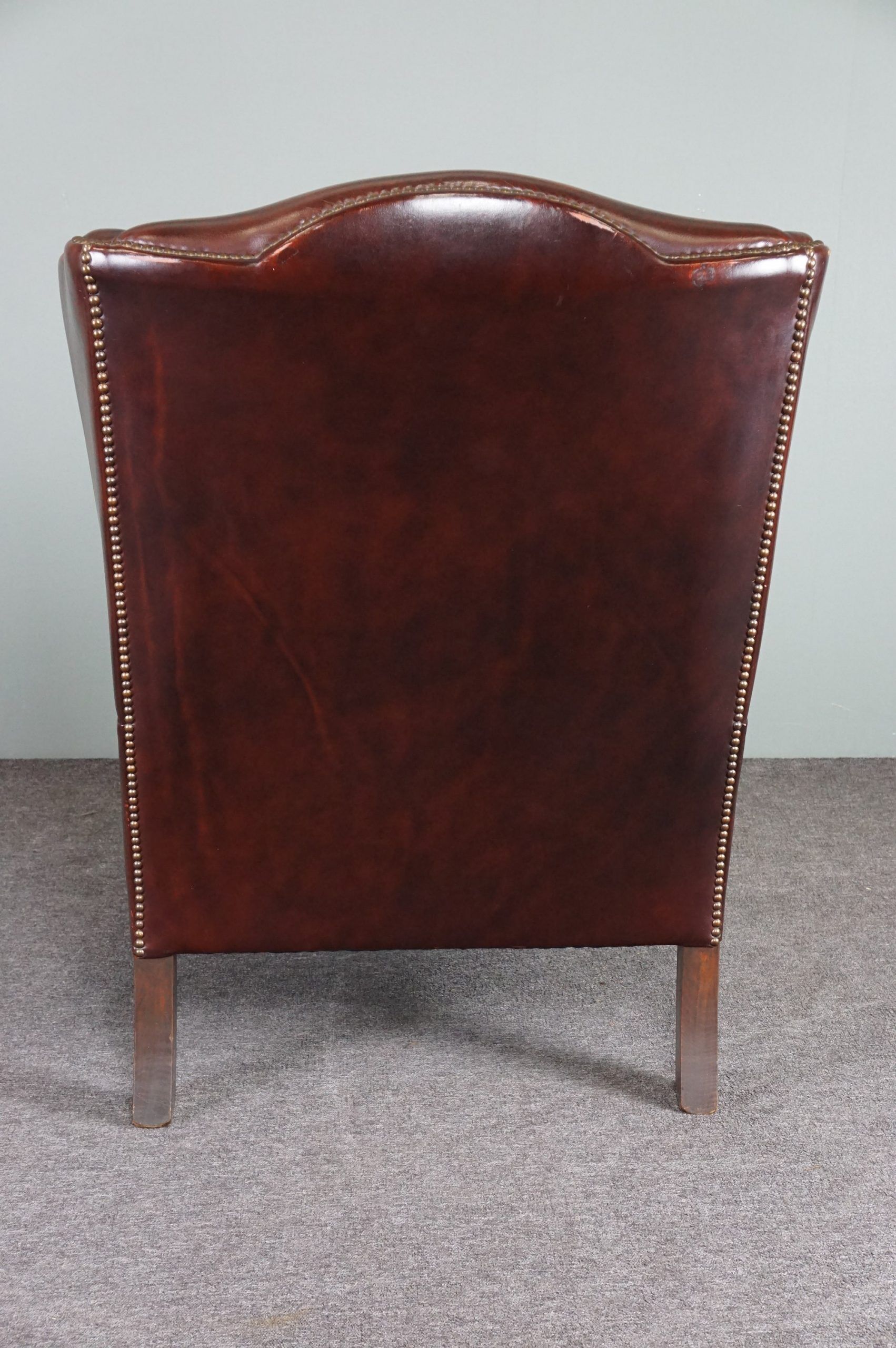 Leather armchair with decorative nails