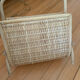 Vintage magazine rack in woven rattan and bamboo.