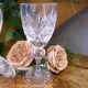 Cut crystal white wine glasses with a slender baluster-shaped stem.