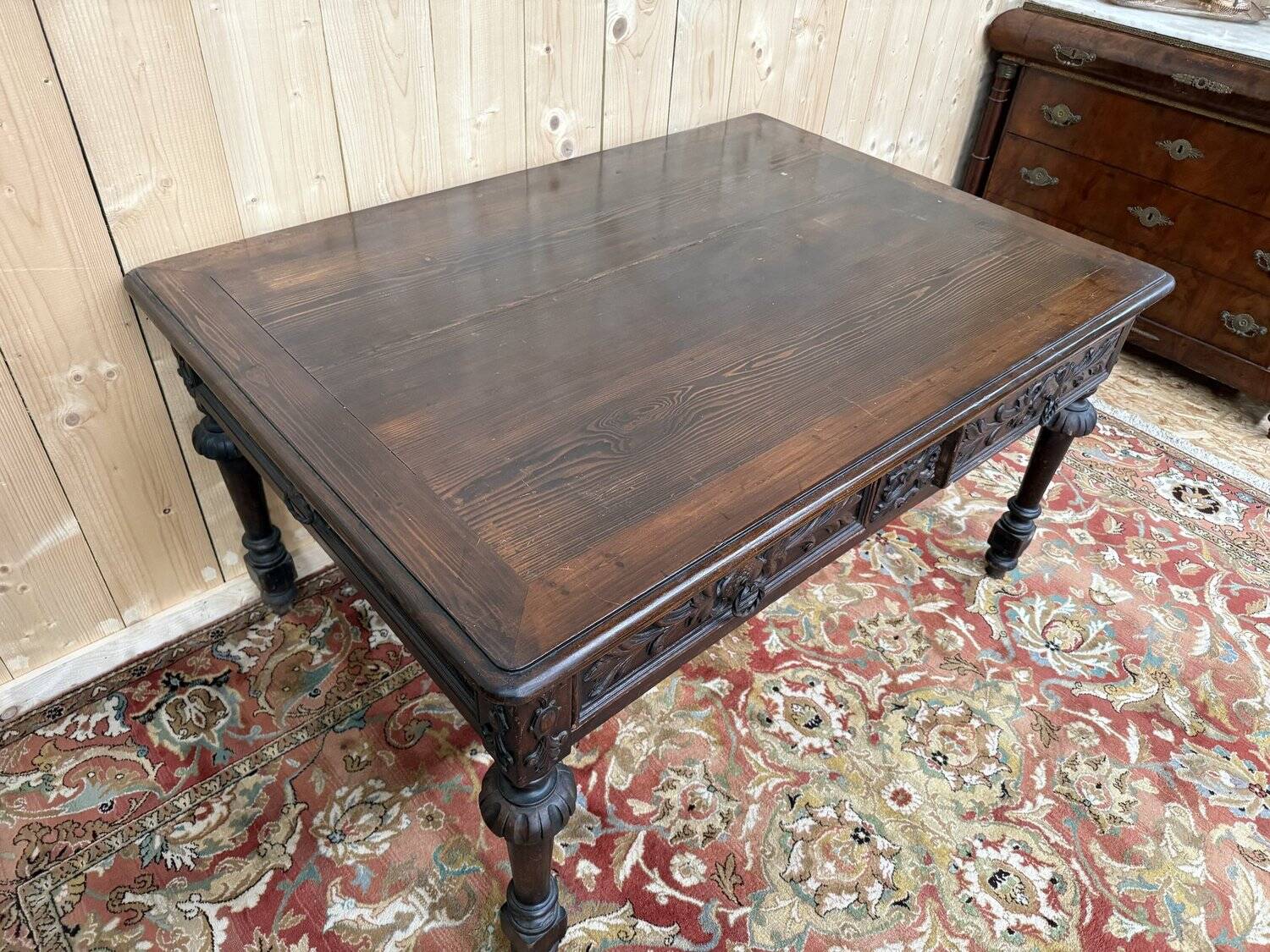 Middle table in a sculpted Louis XIII style living room.