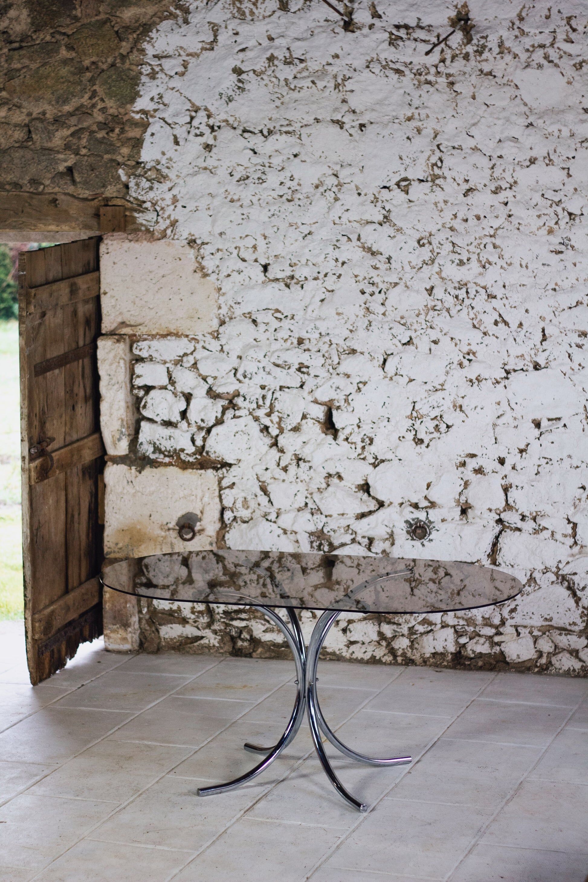 Oval dining table in chrome and smoked glass, 1970.