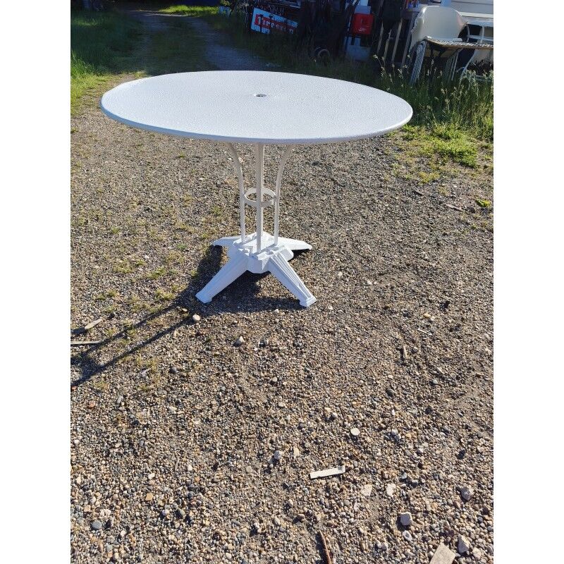 Garden table with a cast iron base and a metal top.