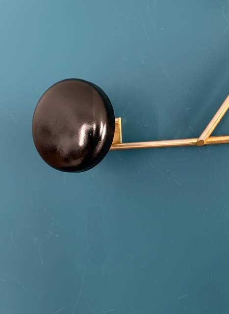 Golden brass coat rack with 3 black vintage hooks from the Mid Century 1950-60.