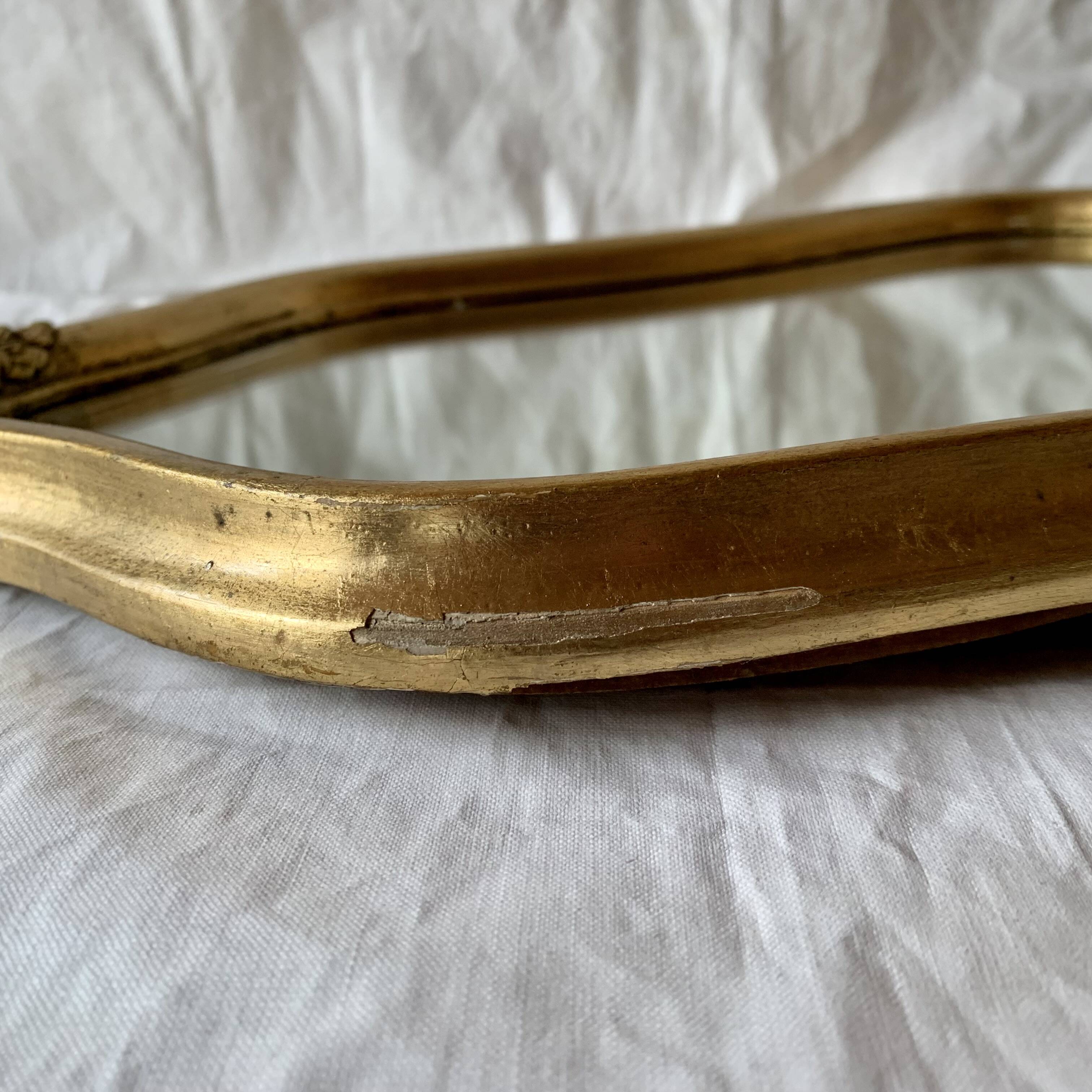 Antique beveled wall mirror in gilded solid wood