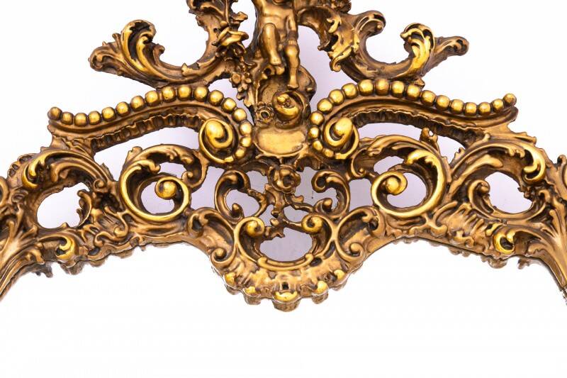 A large mirror in a gold frame, Italy, first half of the 20th century.