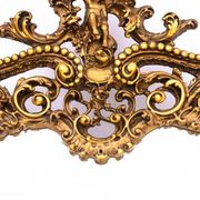 A large mirror in a gold frame, Italy, first half of the 20th century.