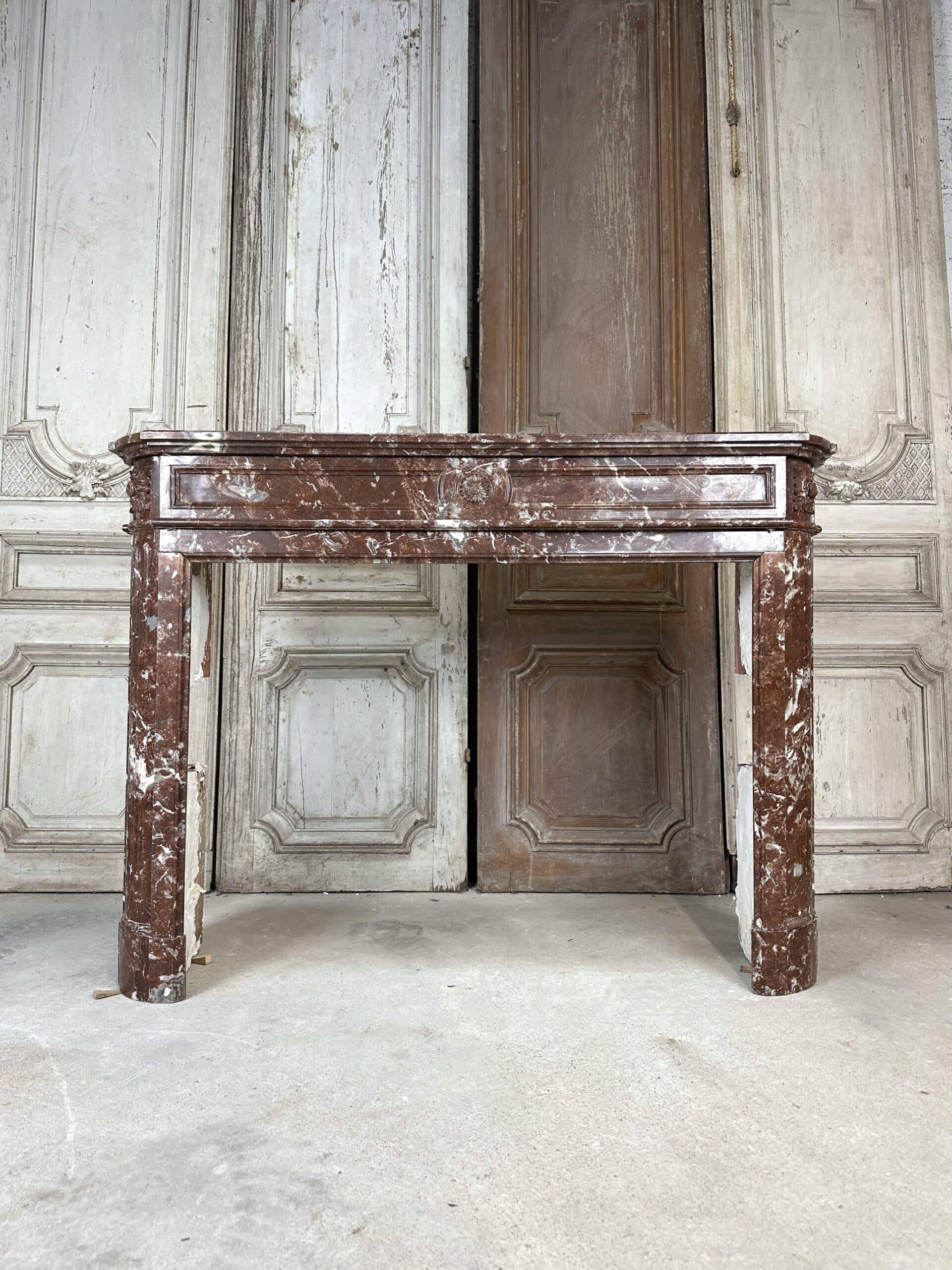 Red marble fireplace in the Louis XVI style, late 19th century