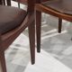 Set of six Italian wooden dining chairs in dark brown faux leather.
