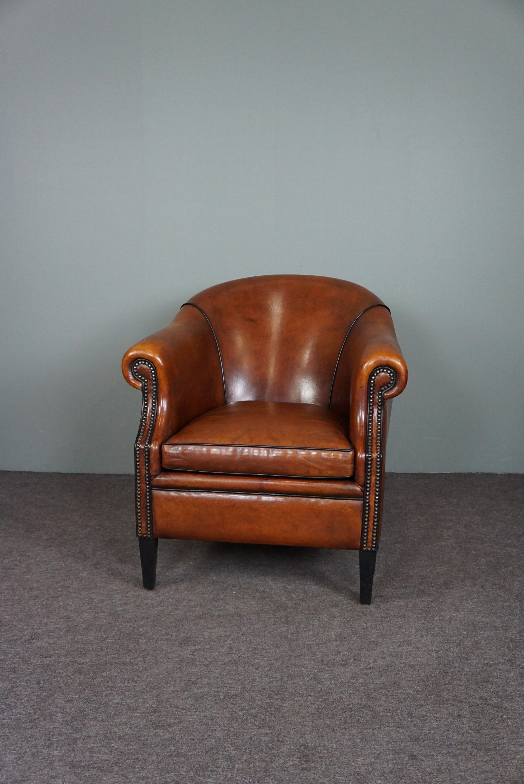 Leather club chair with black piping