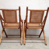 Pair of folding chairs in bamboo and caning, leather and brass