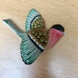 Two exotic birds in slip to hang