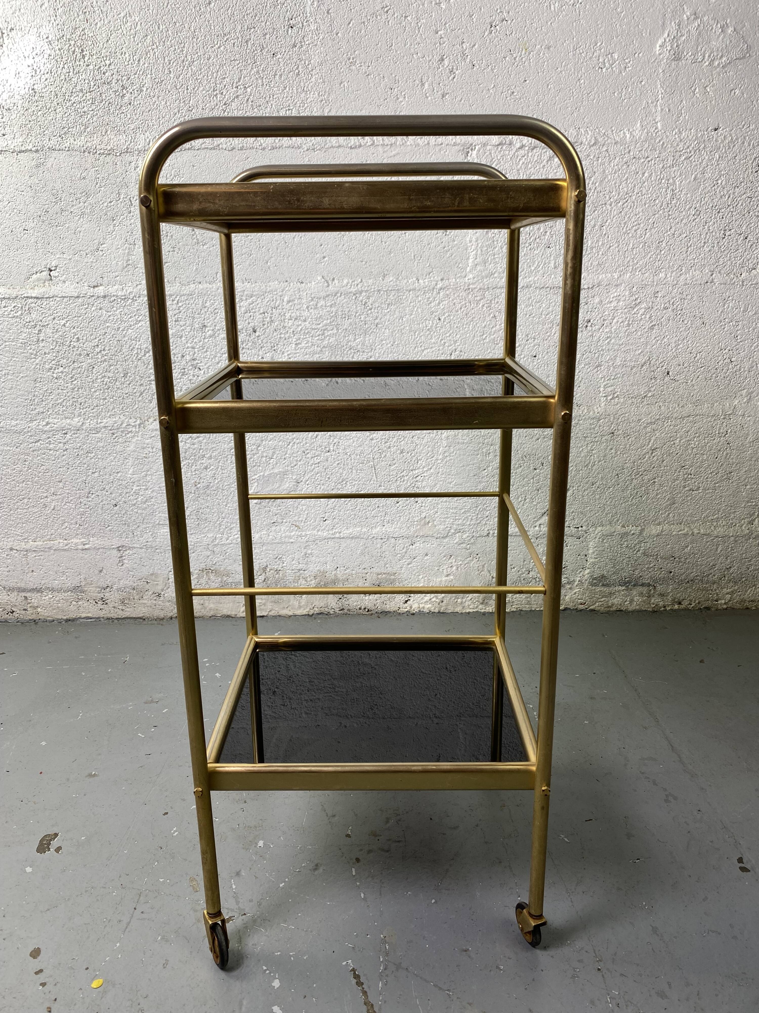 Small rolling trolley in brass and black plastic