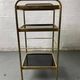 Small rolling trolley in brass and black plastic