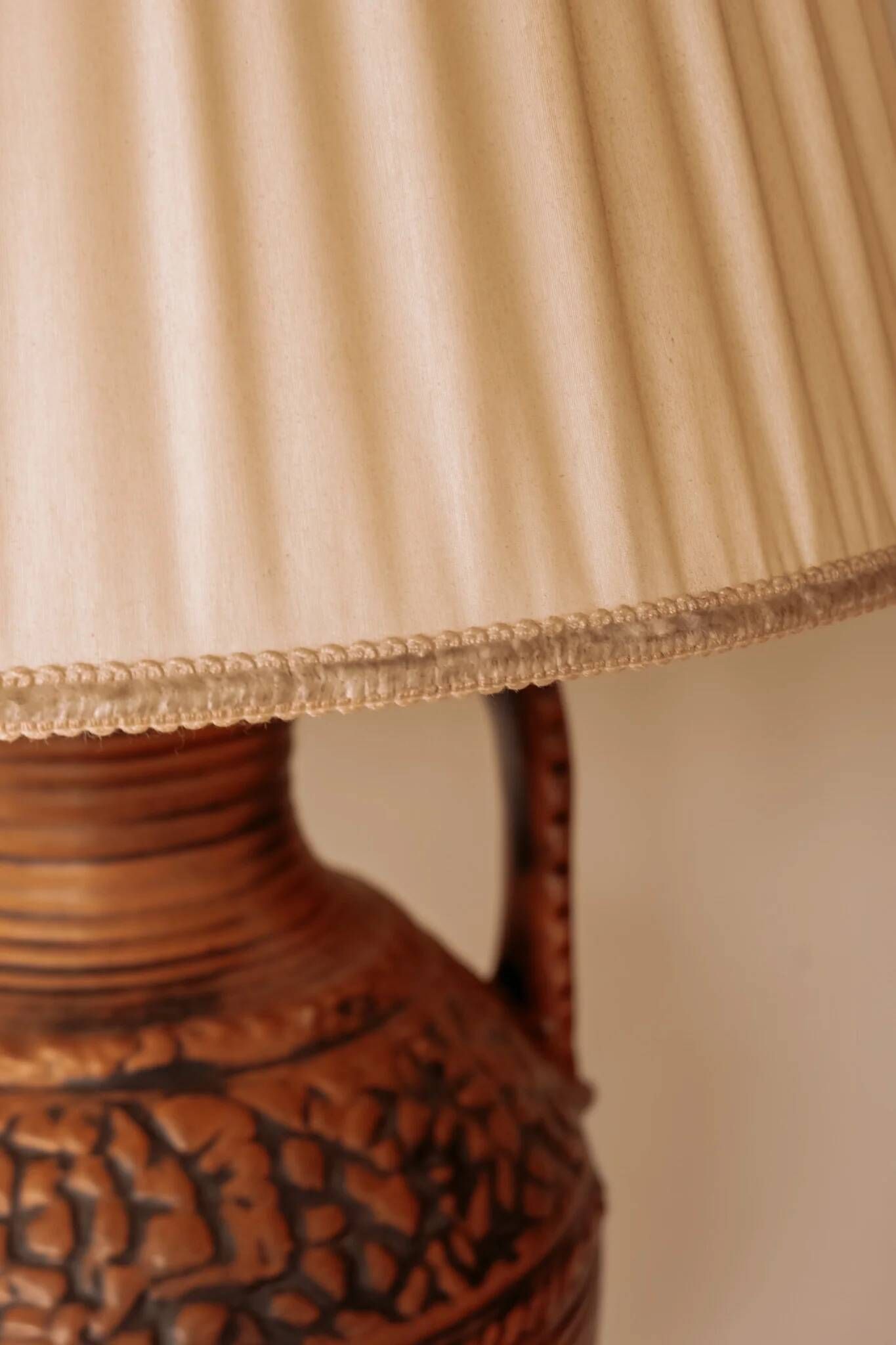Large ceramic table lamp from West Germany with a pleated shade.