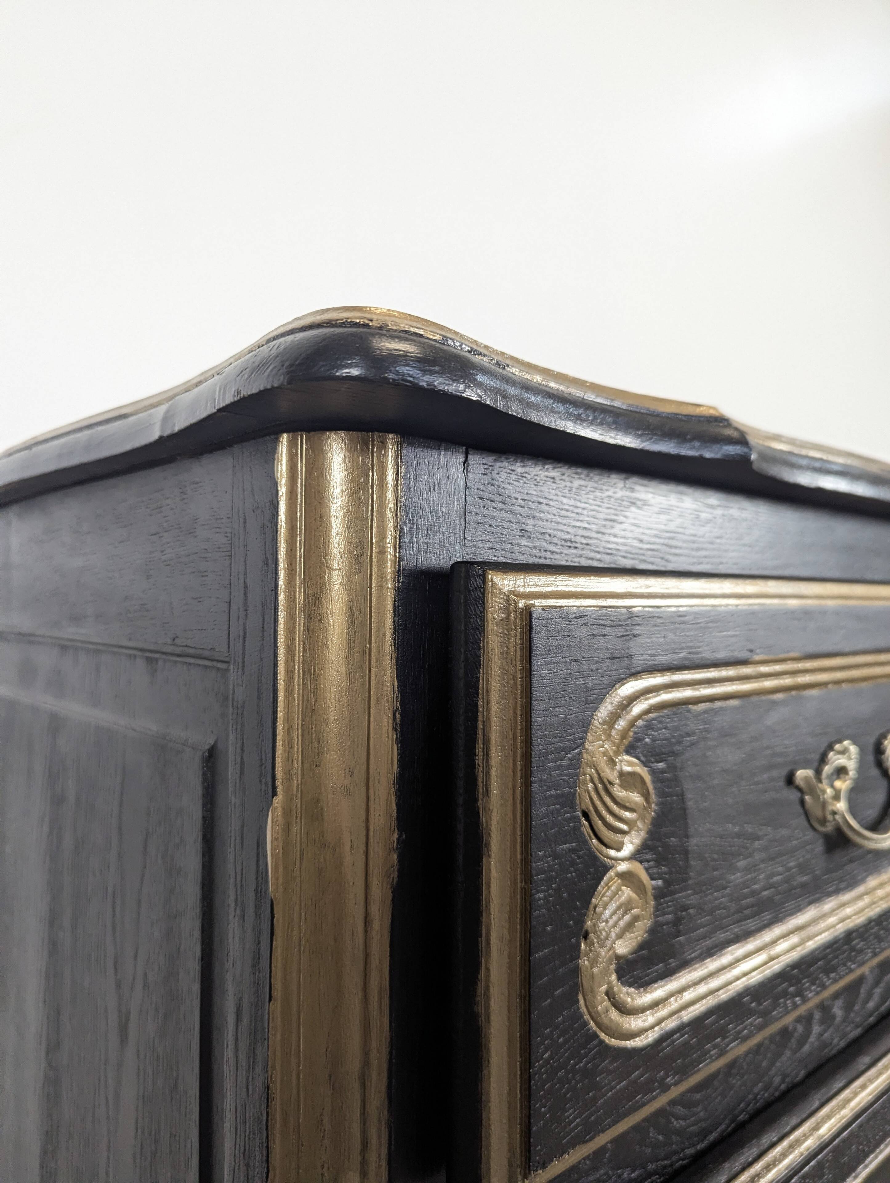 Commode de style Louis XV en chêne laqué noir et rechampi or