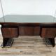Art Deco executive desk in exotic wood, glass, and brass.