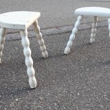 Duo of milking stools with turned legs.