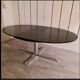 Blackened wooden dining table and chrome foot with integrated butterfly extension