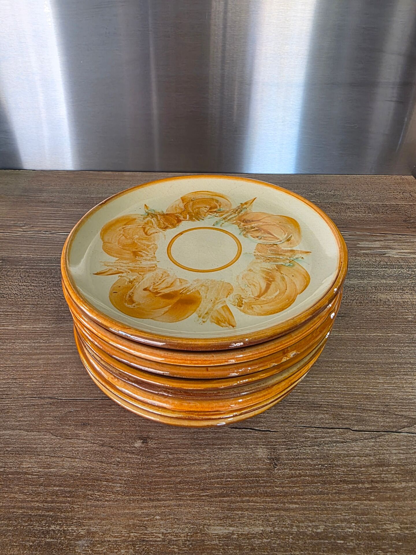 8 vintage dessert plates with a signed decoration.