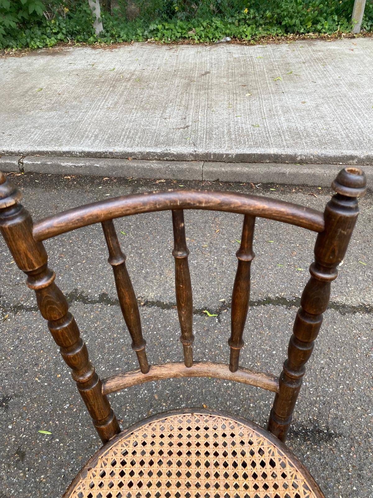 Vintage 19th-century bistro chair made of curved solid wood and caned in the Thonet style.