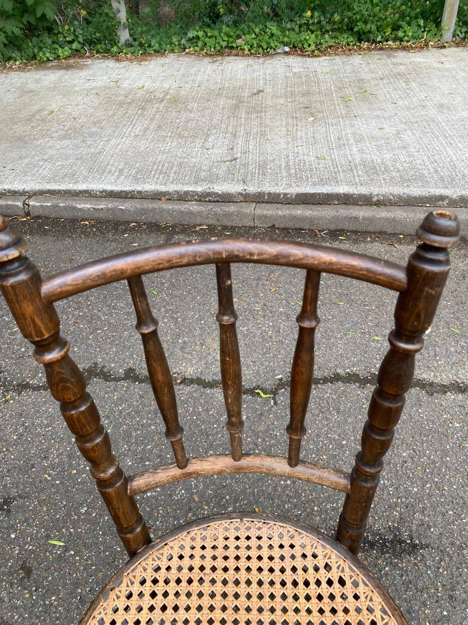 Vintage 19th-century bistro chair made of curved solid wood and caned in the Thonet style.