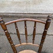 Vintage 19th-century bistro chair made of curved solid wood and caned in the Thonet style.