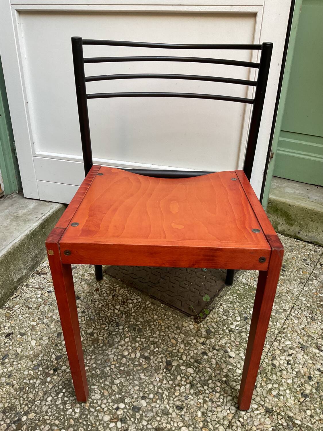 Chair with wooden seat and rare steel back