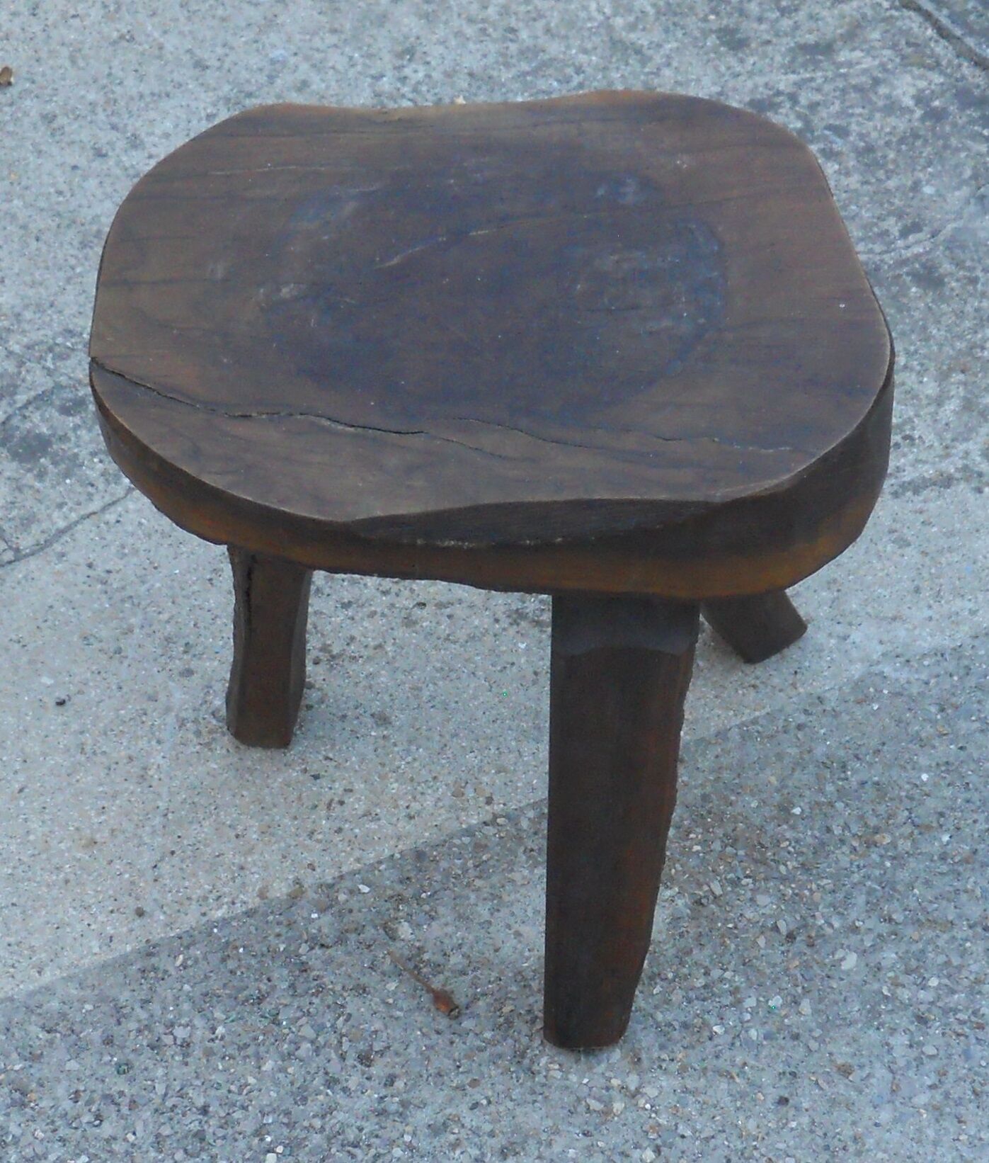 three-legged milking stool made of olive tree folk art