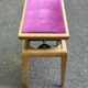 Adjustable piano stool in light beech and purple velvet.