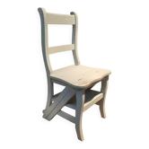 White chair convertible into a staircase.