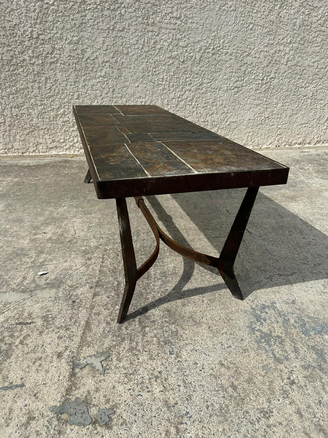 Coffee table with stone top and iron legs