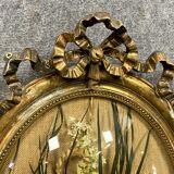 Louis XVI gilded wooden medallion frame with floral arrangement