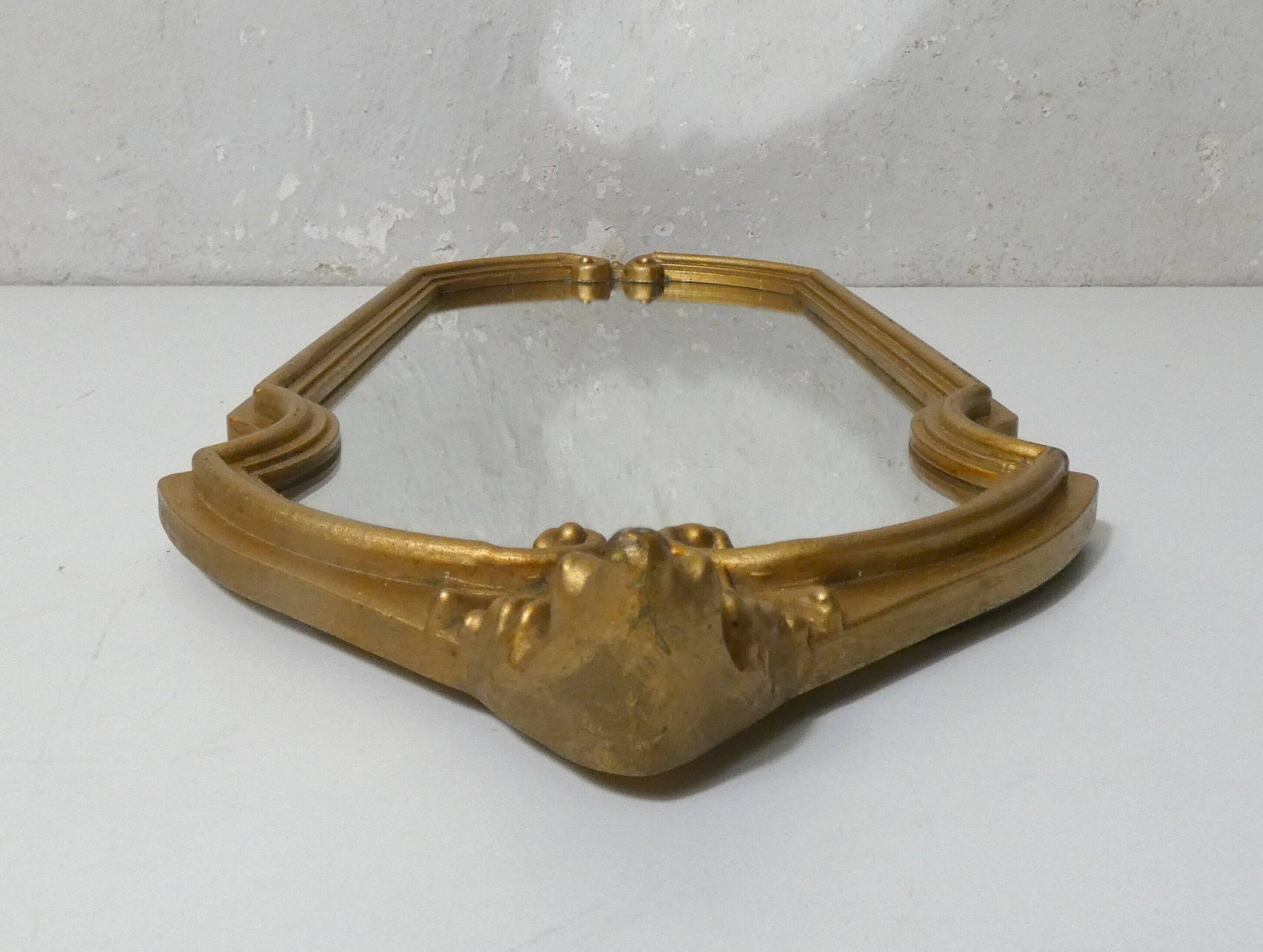 Antique Louis XV style mirror with a vintage carved gold frame.